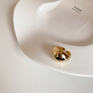 Macro shot of minimalist gold chunky dome ring with a high-polished mirror finish