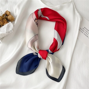 Detailed close-up of a tricolor chain pattern silk scarf with elegant knot styling