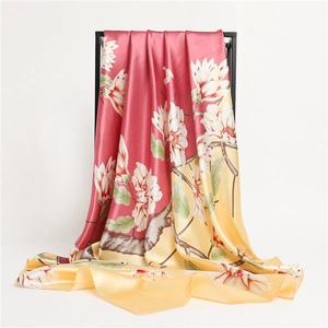 Detailed view of large square silk scarf with red gradient and white magnolia floral print