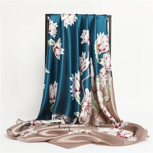 Detailed texture of satin silk scarf featuring elegant magnolia floral print and gradient base