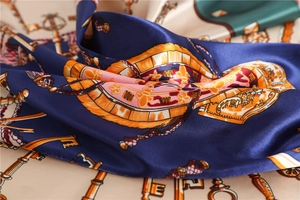 Detailed close-up of vintage silk scarf featuring antique key patterns and tassels