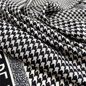 Dettaglio dello scialle di seta a pied-de-poule bianco e nero con bordo jacquard fine