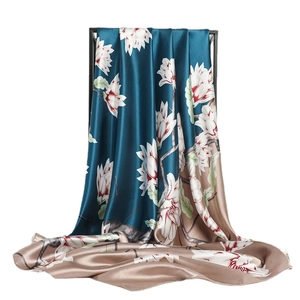 Peacock blue and champagne silk-like scarf featuring realistic white magnolia prints