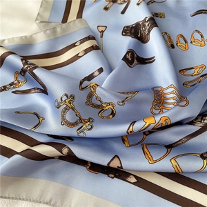 Detail of silk-like scarf featuring classic equestrian bit patterns and satin luster