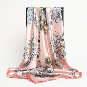 Detail of pink satin scarf with sunflower print and elegant pearl luster texture