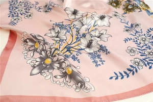 Macro detail of high-quality floral silk scarf featuring lily and sunflower prints