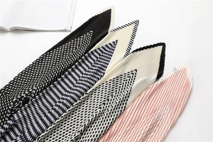 Detailed view of pleated texture and geometric patterns on various chic skinny scarves