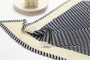 Detail of pleated geometric scarf with striped pattern on elegant minimalist background