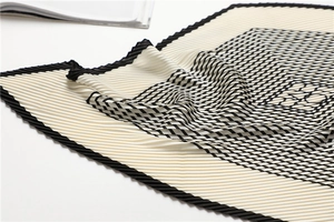 Detail of plissé pleated silk scarf with minimalist black and white geometric stripe patterns