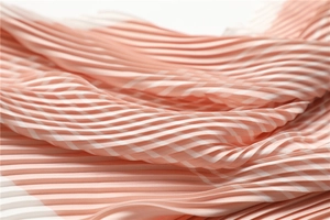 Close-up of pleated pink and white striped chiffon fabric with fine texture details