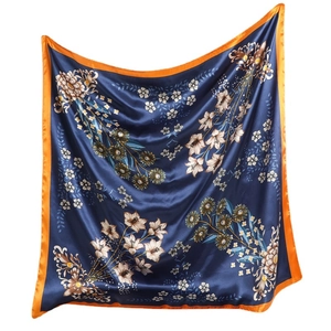 Floral navy blue silk scarf with bright orange edges and elegant hanging drape design