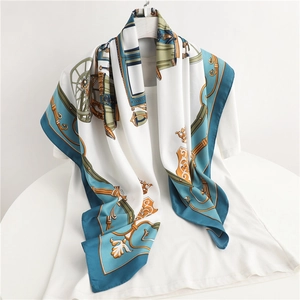 Elegant silk scarf featuring horse carriage patterns draped over a white t-shirt