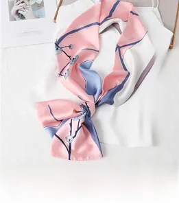 Detail of floral printed silk scarf in pink and blue tied on white top for career look