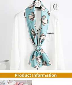 Detail of floral printed silk scarf on white shirt with elegant ginkgo leaf patterns