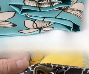 Detailed view of invisible inner stitching on mint green floral silk scarf fabric