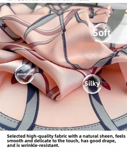 Detail of pink silk scarf with geometric horse bit pattern and smooth glossy texture
