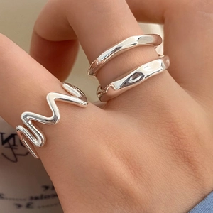 Set of three irregular silver rings with wavy and organic shapes for stacked wear