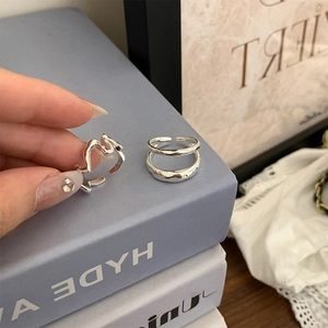 Detailed view of silver stackable rings set with irregular wave and double layer design