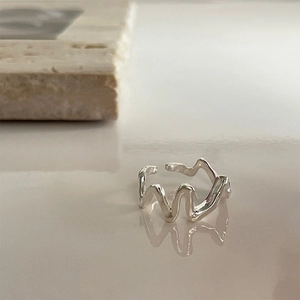Detailed view of the wavy irregular texture on a polished silver minimalist ring