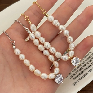 Baroque freshwater pearl necklace with sparkling zircon pendant in gold and silver finish