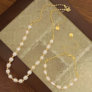 Elegant natural freshwater pearl necklace and bracelet set with gold accent beads