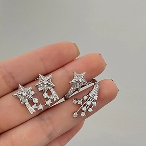 Detail of silver star earrings and open ring set with sparkling cubic zirconia
