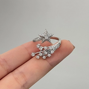 Macro shot of silver star ring with rhinestone shooting star tail and pavé crystals