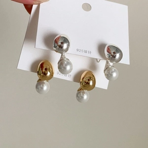 Detail of gold and silver ball pearl earrings with 925 silver needles on display card
