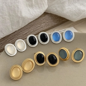 Elegant geometric cat eye stone earrings with matte gold and silver metal frames