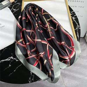 Elegant chain print silk scarf with vintage belt pattern on a black marble background