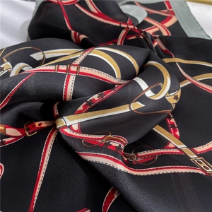 Close-up of luxury satin scarf with vintage equestrian strap and buckle patterns