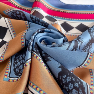 Detailed view of square silk scarf with pineapple print and geometric pattern