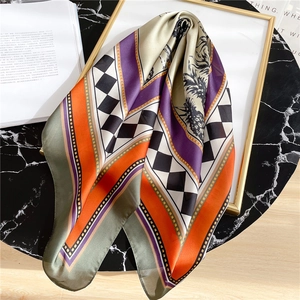 Silk texture square scarf with color block plaid and pineapple pattern on marble table