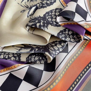 Macro detail of high-quality silk scarf featuring pineapple patterns and geometric textures