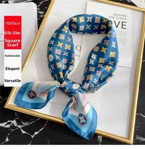 Detailed close-up of 70cm silk-like scarf with blue floral patterns on a gold frame