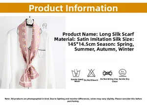 Detail of pink faux silk neck scarf featuring white daisy patterns and satin finish