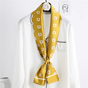 Yellow long silk scarf with daisy prints tied on a white shirt collar for elegant styling