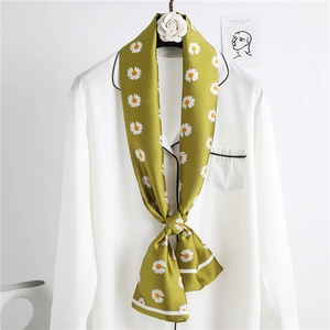Elegant olive green daisy print silk-like long scarf tied on a white shirt collar