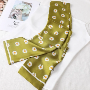 Grass green daisy print long silk scarf for women elegantly styled on white clothes