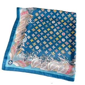 Elegant silk scarf featuring teal swan and floral prints with smooth satin texture