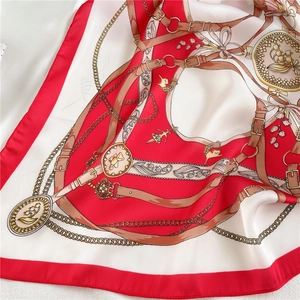 Detail of silk scarf showing vintage chain print and elegant floral patterns with a smooth texture