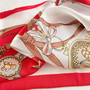 Close-up of silk scarf with red, gold, and white bear patterns and premium satin texture