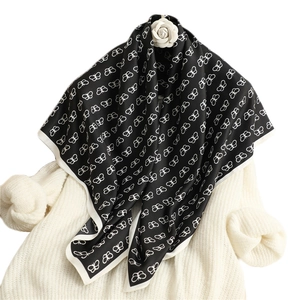 Elegant black silk square scarf featuring white butterfly prints and a contrast border