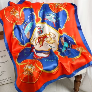 Close-up of a 90cm silk scarf draped on a chair showing carriage and crest patterns