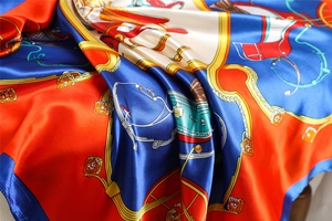 Detailed macro view of horse carriage print on smooth satin silk square scarf