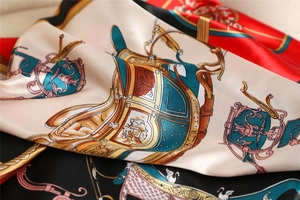 Close-up of silk square scarf featuring vintage carriage patterns and satin finish