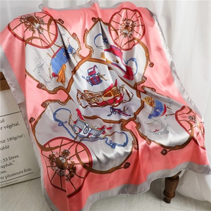 Close-up of pink and grey satin silk scarf with vintage carriage patterns on chair