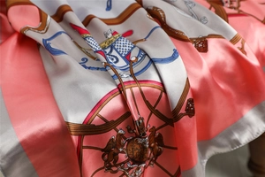 Detail showing smooth satin texture and elegant classical horse carriage print on silk scarf