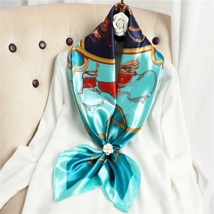 Detailed view of luxury silk scarf with classical carriage print and white floral ring buckle