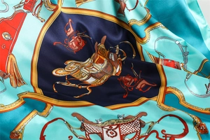 Detailed view of silk square scarf featuring equestrian saddle and bridle patterns